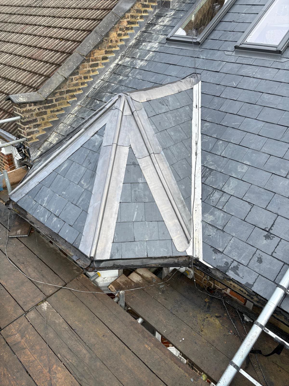 Lead-covered hips on a slate bay roof