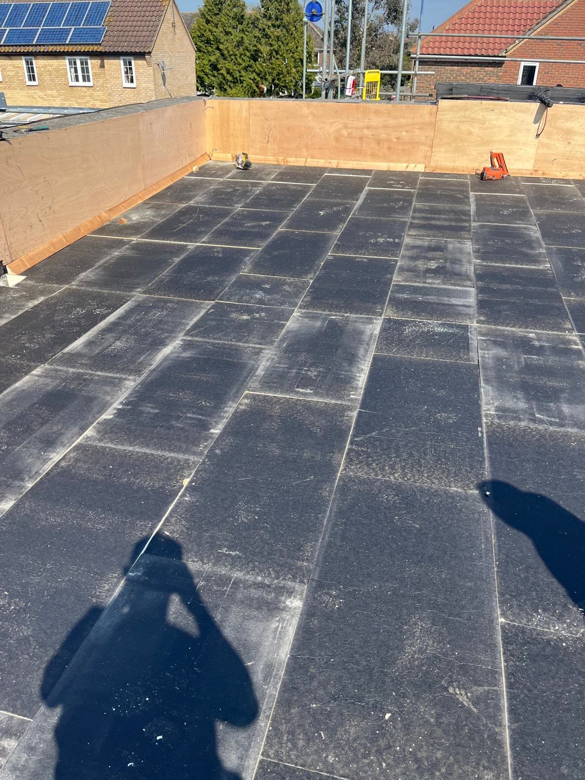 Large flat roof with the new top layer going down