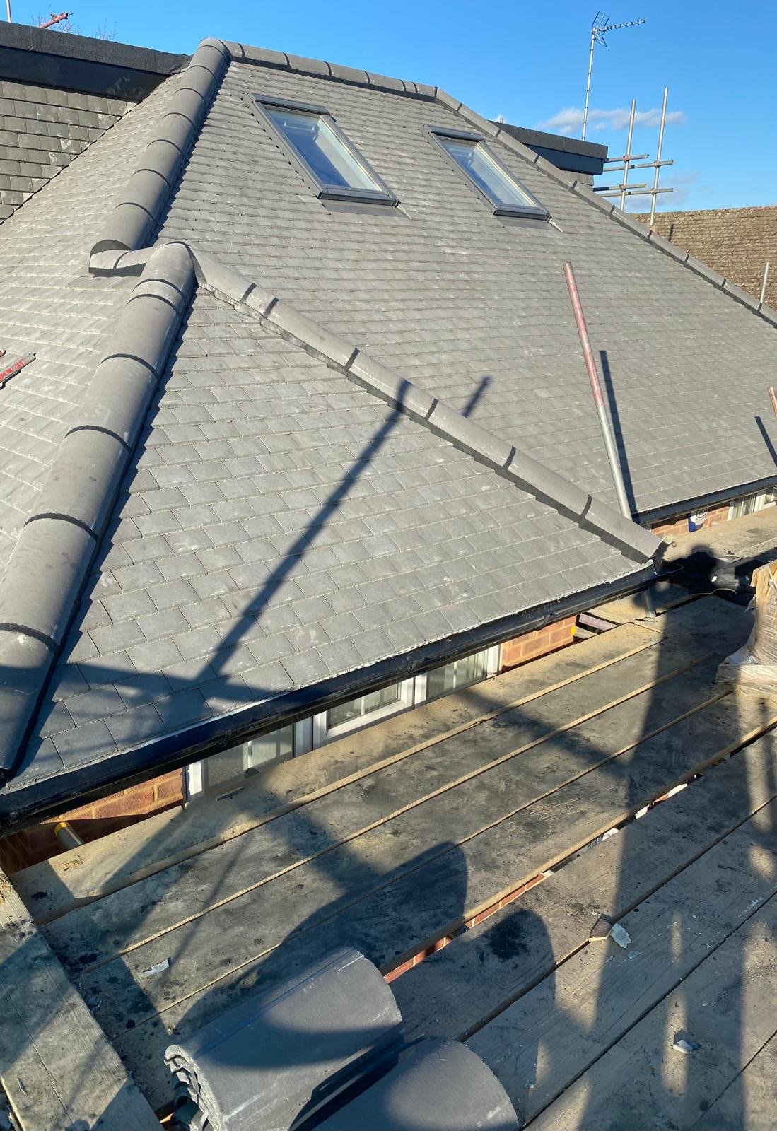Grey pin tile roof with two new roof windows